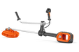 Side view of a Husqvarna brush cutter with ergonomic handle and battery compartment.