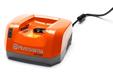 Side view of a Husqvarna QC500 battery charger with a power cord.