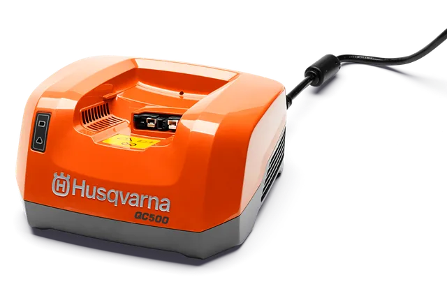 Side view of a Husqvarna QC500 battery charger with a power cord.