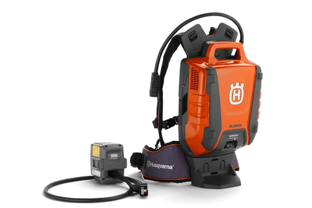 Side view of a Husqvarna battery backpack with a connected charger.
