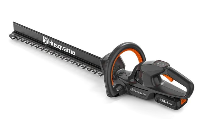 Side view of a Husqvarna hedge trimmer showcasing its ergonomic handle and cutting blade.