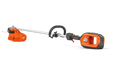 Side view of a Husqvarna battery-powered grass trimmer with ergonomic handle.