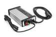 Front view of a Husqvarna battery charger with attached cables.