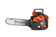 Side view of a Husqvarna chainsaw with visible branding and chain.
