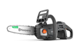 Side view of a Husqvarna chainsaw with ergonomic handle and visible controls.