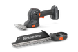 Front view of a Husqvarna handheld gardening tool with interchangeable blades.