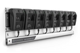 A Husqvarna charging rail with eight battery chargers mounted on it.