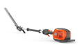 Side view of a Husqvarna battery-powered hedge trimmer with an extended pole.