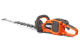 Side view of a Husqvarna hedge trimmer with ergonomic handle.