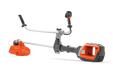 Side view of a battery-powered grass trimmer with ergonomic handle and cutting head.